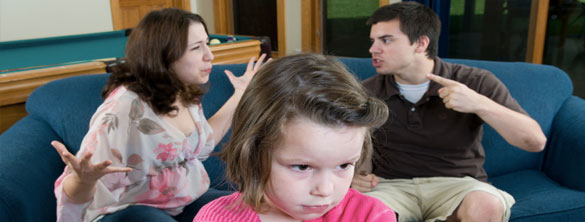 Photograph of couple arguing with a child in the foreground